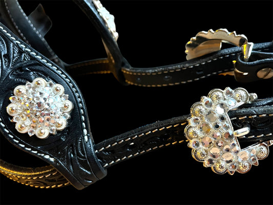 Zoom sur les conchos et les strasse de la bride de show en cuir noir 